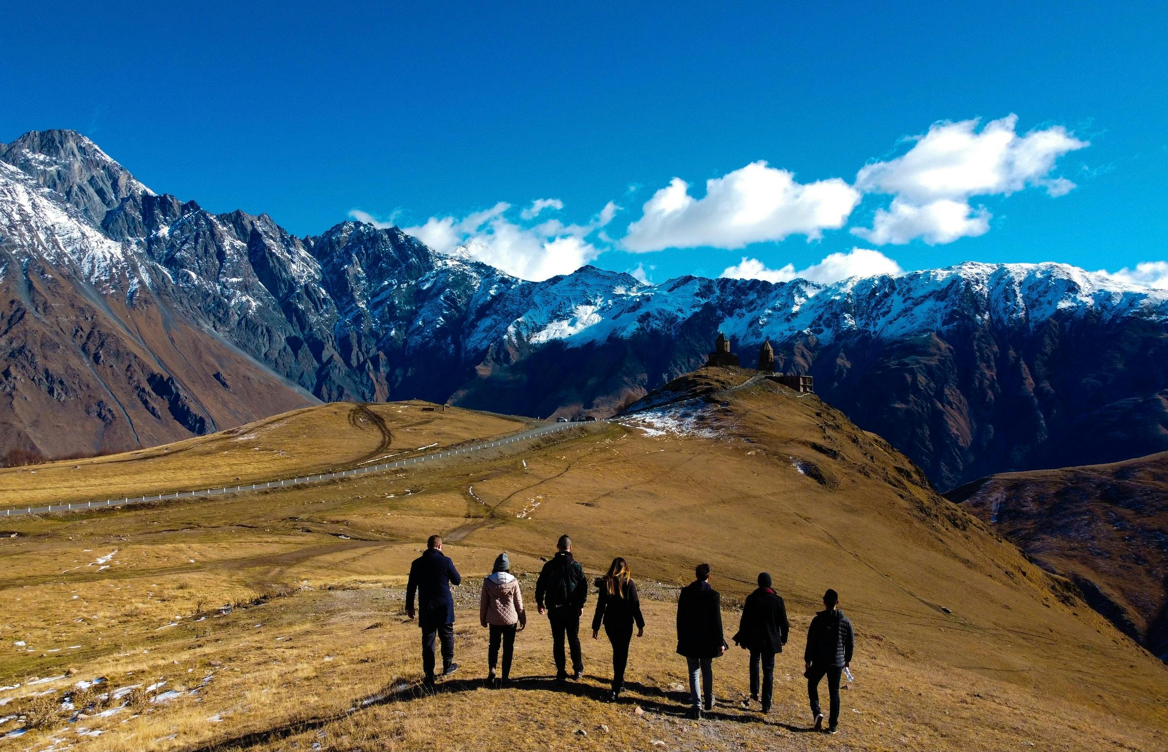 Group of people traveling mountain.